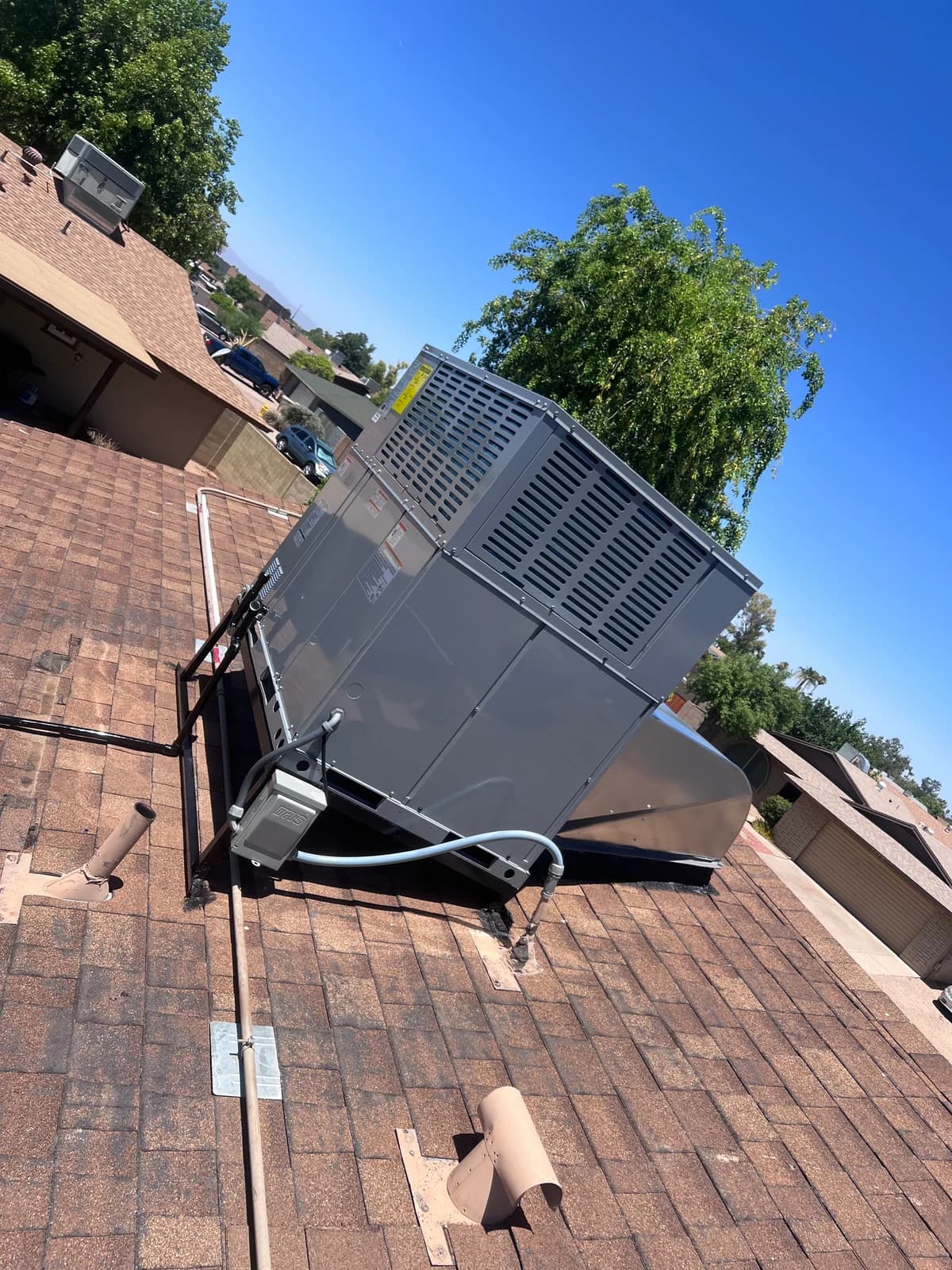 New rooftop packaged HVAC system installed on a secure support frame