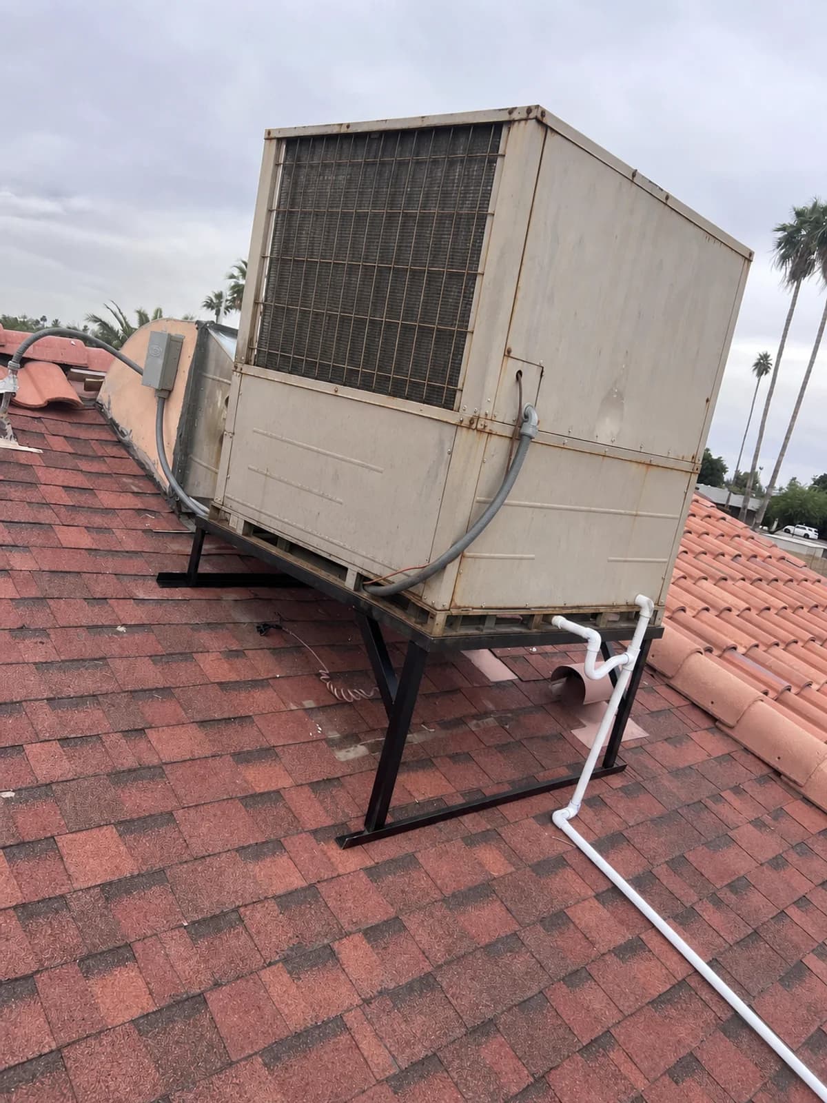 Illustrative view of an older weathered rooftop HVAC package unit at the project site