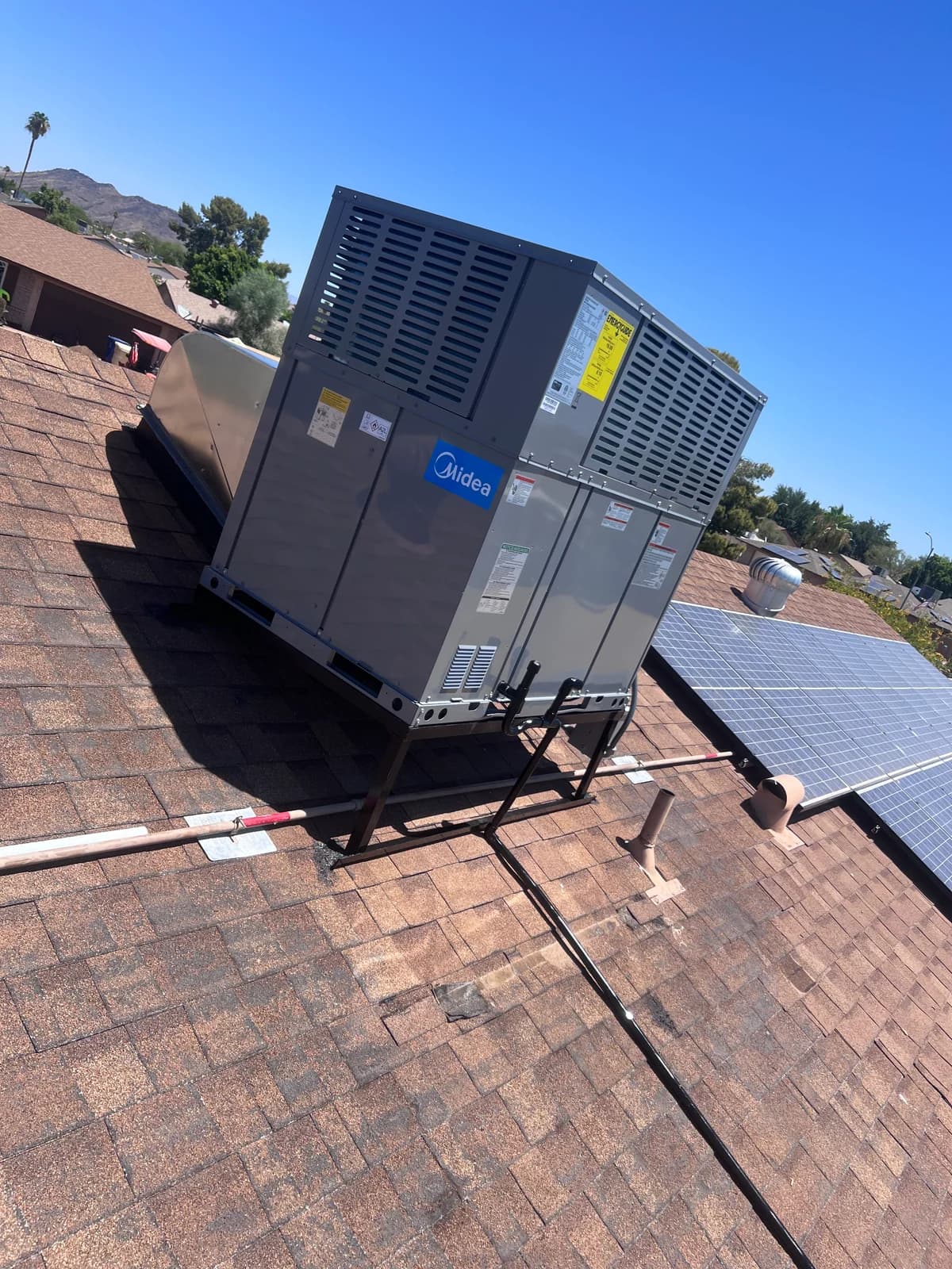 Rear view of the completed rooftop HVAC installation and organized connections