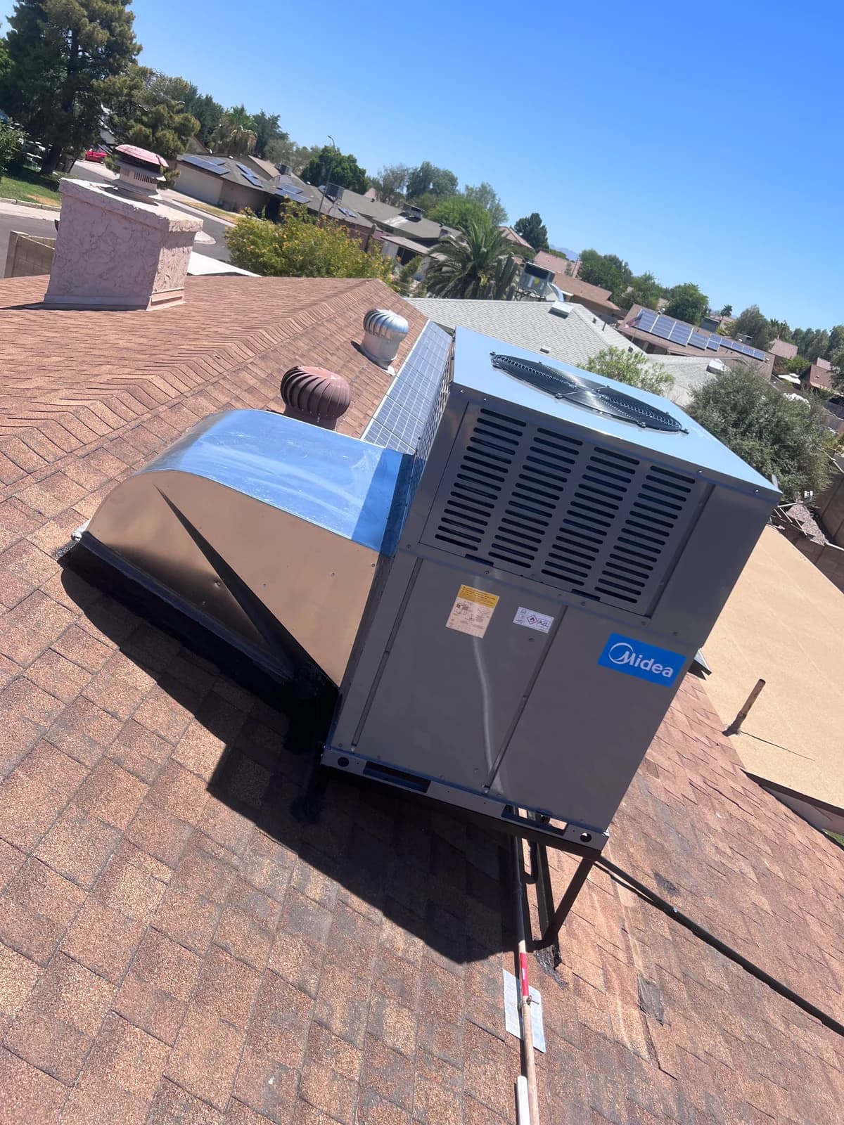 Completed rooftop HVAC installation with new duct transition and clean roof work