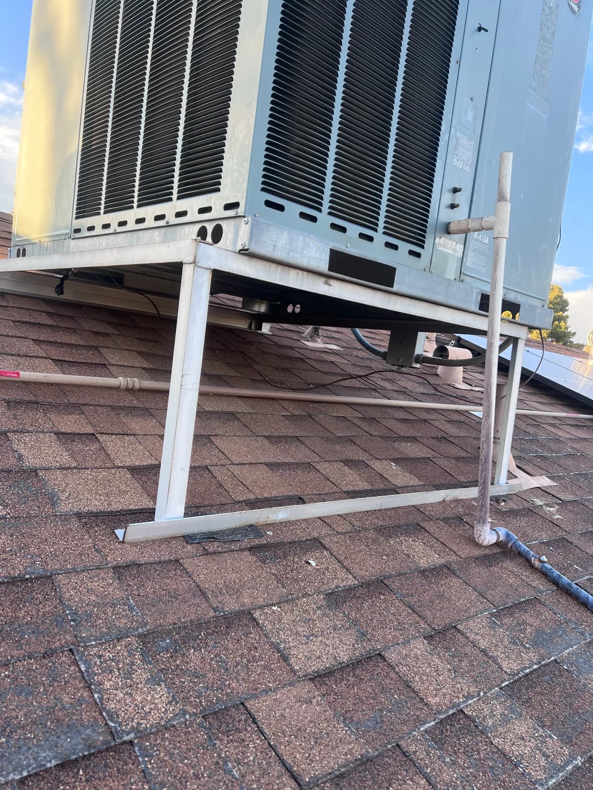 Original rooftop HVAC support frame and line routing before replacement