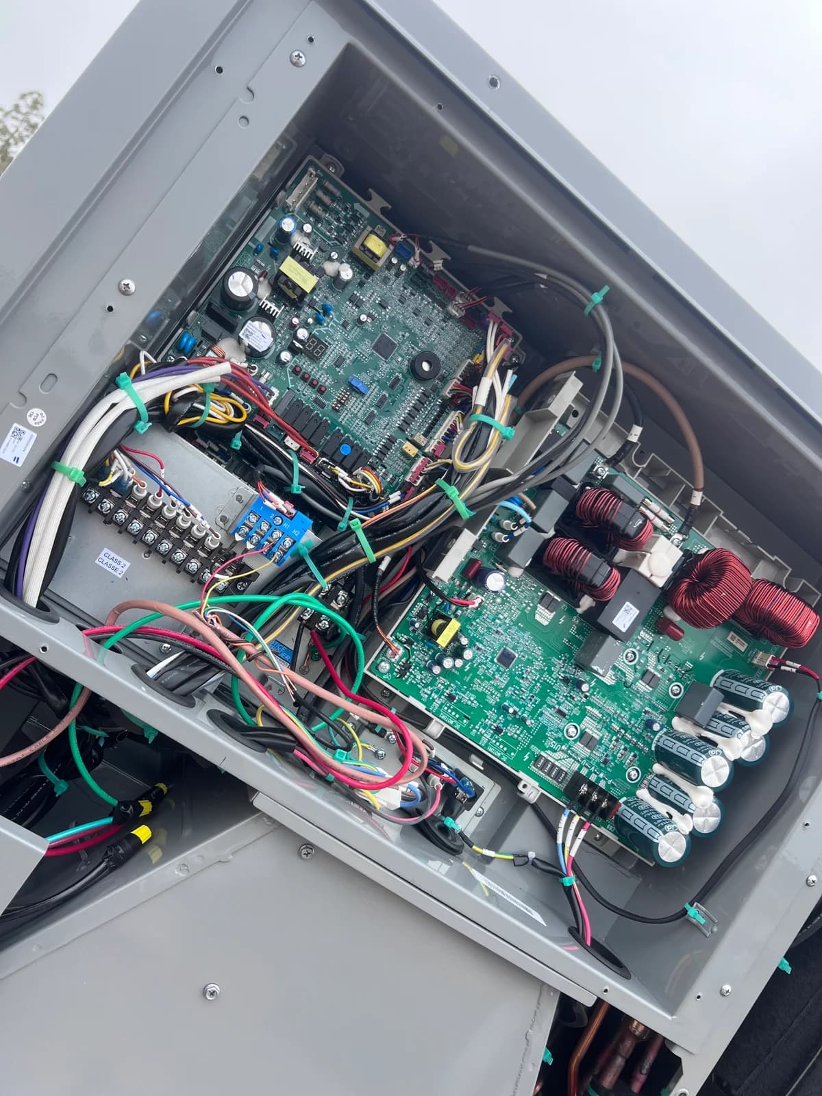 Electronic HVAC control board and organized field wiring inside the unit