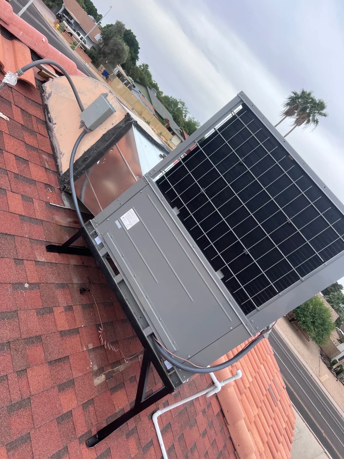 Front view of the rooftop packaged HVAC unit and surrounding work area