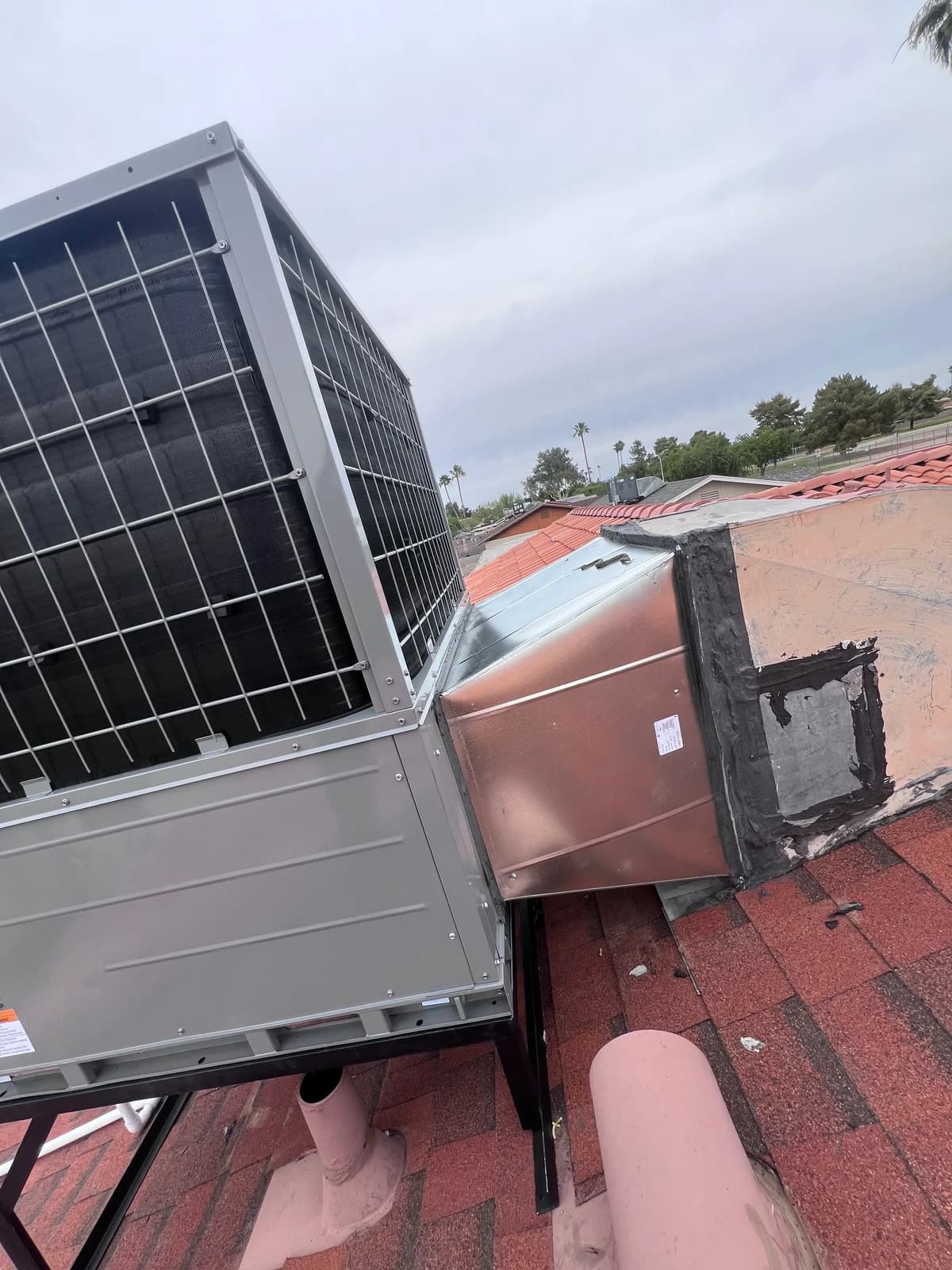 Side view of the rooftop unit and sheet metal transition connection