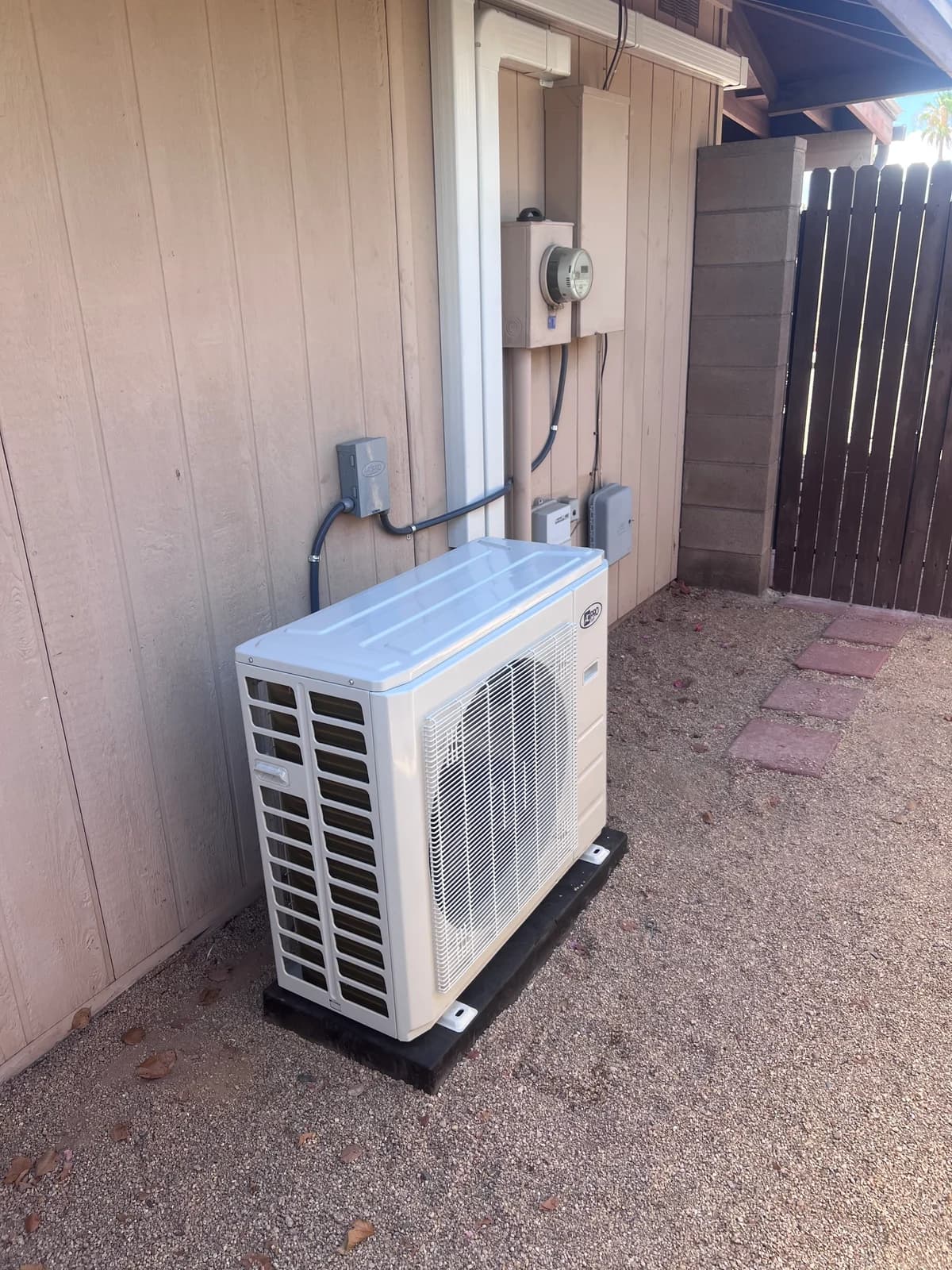 Finished outdoor mini split condenser with neat electrical and covered refrigerant line routing